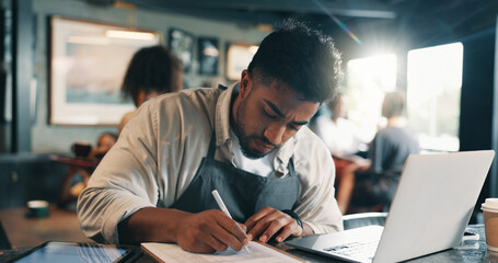 Business owner, laptop and man in restaurant, writing and planning for food menu, taxes report and...
