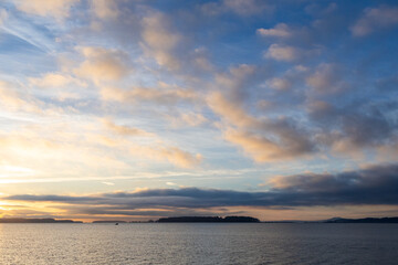 Scenic Ocean View with Vibrant Sky and Gentle Clouds at Sunset