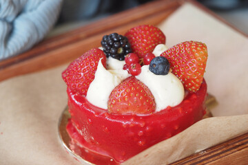 Delicious dessert with fresh berries on a wooden platter