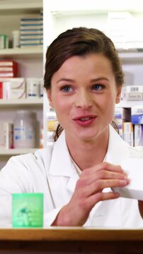 Pharmacist assisting the bottle of drug to customers