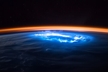 Mesmerizing blue sunrise over Planet Earth’s horizon viewed from outer space, showcasing a stunning celestial scene