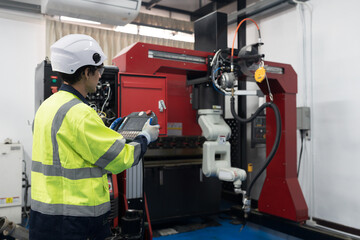 Male engineer control automatic robotic hand machine welding in building room workshop. Male...
