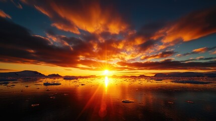 Obraz premium Breathtaking Sunset Over Tranquil Arctic Ocean with Dramatic Clouds