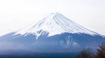 Majestic Snow-Capped Mountain Peak Ascending Into The Tranquil White Sky