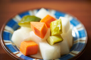 Pickled radish in vinegar on a plate,