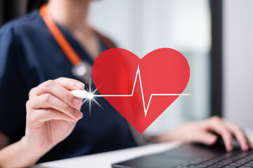 Professional healthcare medical worker holding red heart with cardiogram cardiologist concept