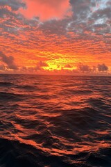 Stunning sunset reflects off ocean surface, creating a fiery, atmospheric view