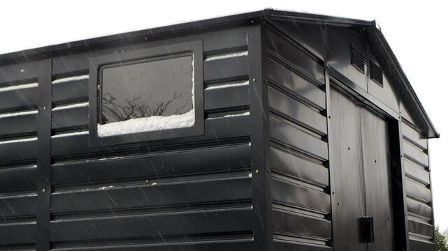 Toolshed in the winter while snowing