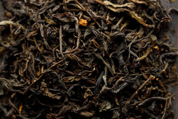 Japanese or Chinese jasmine tea leaf on black ceramic plate on white background.