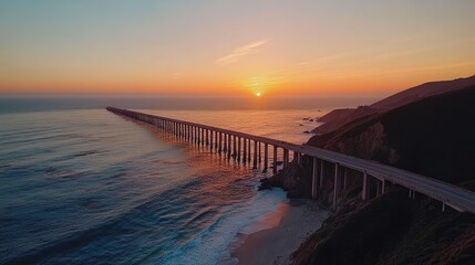Obraz premium A breathtaking aerial view of a long bridge stretching over the ocean at sunset, with warm hues of orange and pink lighting up the sky and water