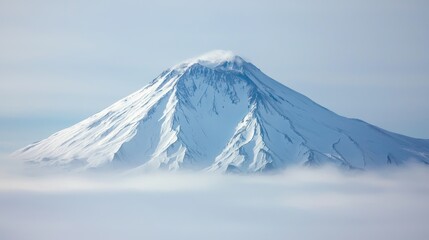 Snow-covered mountain peak with freezing temperatures and mist.