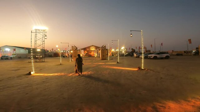 Young Woman Entering Decorated Rann Utsav Tent at Night