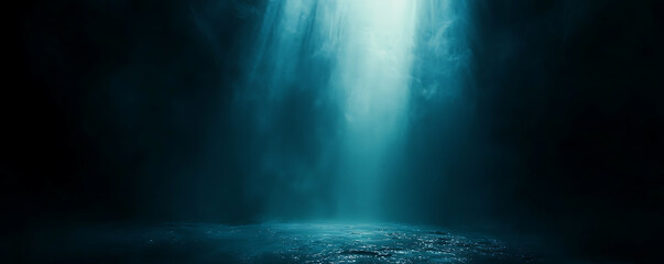 A dark, mysterious scene illuminated by a soft, focused beam of blue light shining onto a textured floor, creating a cinematic, moody, and atmospheric effect.