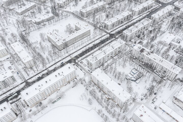 Fototapeta premium winter cityscape. apartment buildings complex, covered with snow. aerial view.