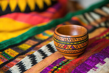 Kwanzaa celebration with unity cup and African textile backgrounds