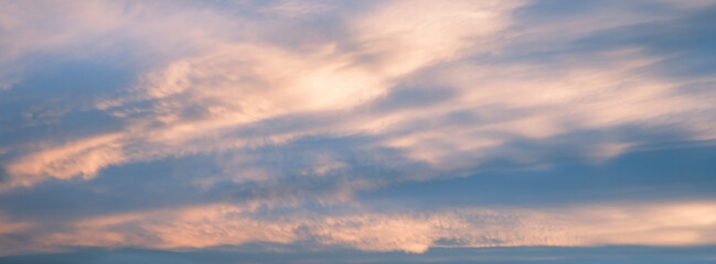 Cirrus cloud with sunset light over blue sky.  nature wallpaper  background.