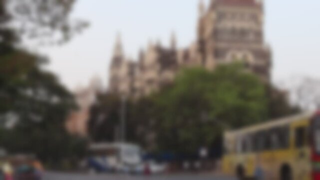 Blurred view of vehicle traffic on the Mahatma Gandhi Road and Oriental Building at the background in Mumbai, India.