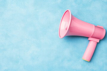 A vibrant pastel pink megaphone placed against a textured light blue background, offering a playful and bold visual contrast. The composition is clean and minimalistic, generative ai