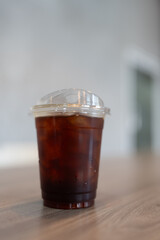 Close up of a plastic cup of iced americano, a refreshing iced black coffee