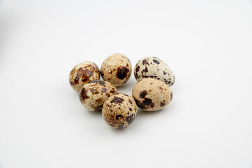 The Common quail (Coturnix coturnix) eggs on a white background.