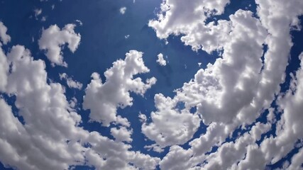 Stunning Aerial View of Cumulus Clouds Swirling Across a Vivid Blue Sky - Powered by Adobe