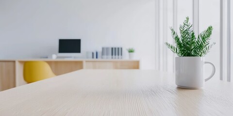 Naklejka premium Modern minimalist office workspace with a small plant in a white cup. Light wood desk, yellow chair, computer. Bright and airy, calm atmosphere