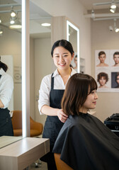 Obraz premium Hairstylist Cuts Client's Hair in a Modern Hair Salon