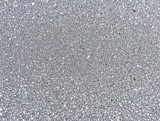 sparkling silver glitter surface with densely packed particles creating a festive and shimmering effect for celebration concepts