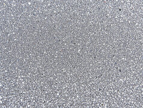 sparkling silver glitter surface with densely packed particles creating a festive and shimmering effect for celebration concepts