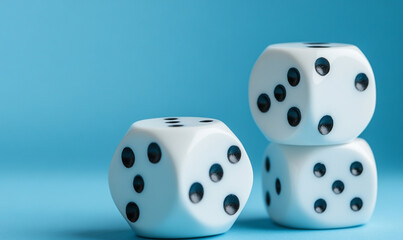 White dice stacked on blue background for board games and gambling activities.
