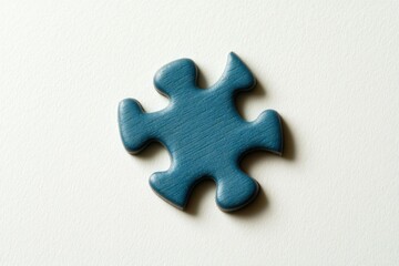 Obraz premium Single blue wooden puzzle piece on a white background