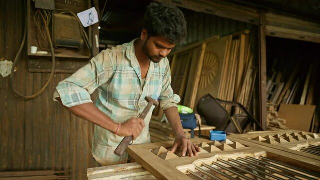 Artisan secures nails into wood using a sturdy hammer
