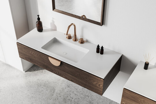 Modern bathroom sink with wooden vanity and bronze faucet on light background. 3D Rendering