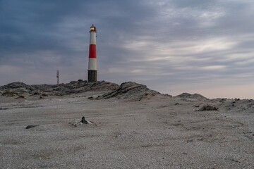 A beautiful, isolated lighthouse in a desolate landscape in Luderitz, Namibia