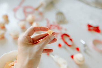 Hand holding kiss me conversation heart