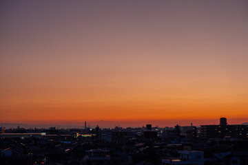 Naklejka premium 夕焼けに染まる都市のパノラマ風景
