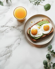 Breakfast table with poached eggs on toast, juice, and fresh egg