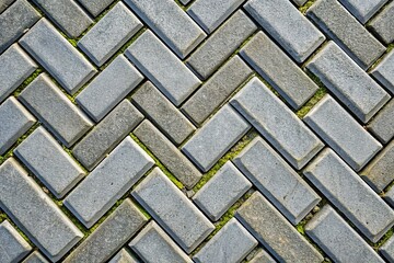 Aged Herringbone Pavement Texture - Macro Closeup of Grey Interlocking Bricks