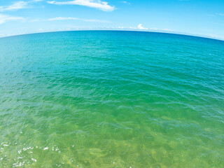 Aerial view of blue sea surface water texture background,Sun reflections on water, Aerial flying drone view Waves water surface texture on sunny tropical ocean in Phuket island Thailand