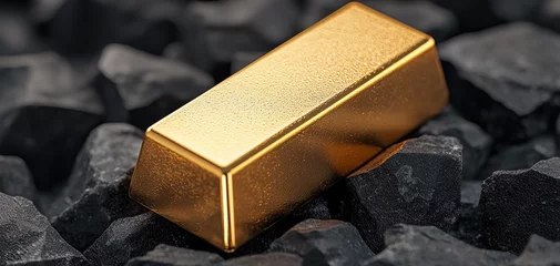 Gardinen A shiny gold bar rests on a bed of dark stones, reflecting light and showcasing its metallic luster. © Leninya