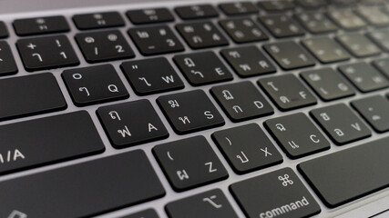 Closeup of a computer keyboard on a white background showing keys and buttons