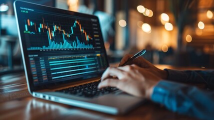Professional working on financial data analysis using a laptop in a modern office environment during the evening