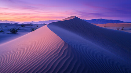 Purple desert sand dune at sunrise, mountains background, travel photography