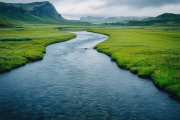 A tranquil scene in the highlands of Iceland, featuring a clear river meandering through lush fields.