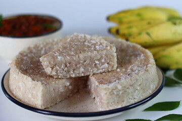 Paputtu or Paal Puttu made with matta rice, a Kerala brown rice, served with chickpea curry and plantain