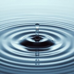 Water droplet creating ripples in still water, showcasing the beauty of nature's movement and tranquility