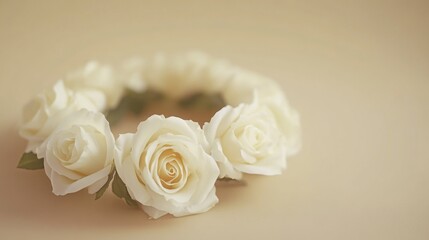 Obraz premium A delicate floral arrangement of white roses forming a headpiece, suitable for bridal wear or as a decorative accessory.