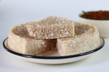 Paputtu or Paal Puttu made with matta rice, a Kerala brown rice, served with chickpea or Kadala masala curry.