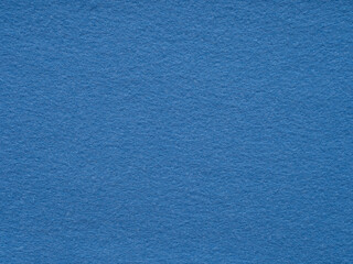 A serene expanse of textured blue felt creates a calm, minimalist backdrop