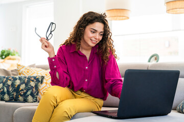 Beautiful young woman with colorful attire at home - Cheerful pretty female adult spending quality...